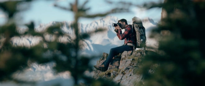 IMAGE: Still – Rack focus through trees, Mike on the edge of the cliff