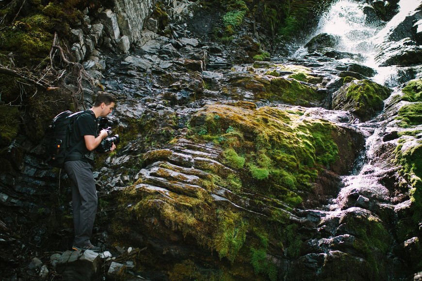 IMAGE: Photograph – Steve Seeley filming a waterfall